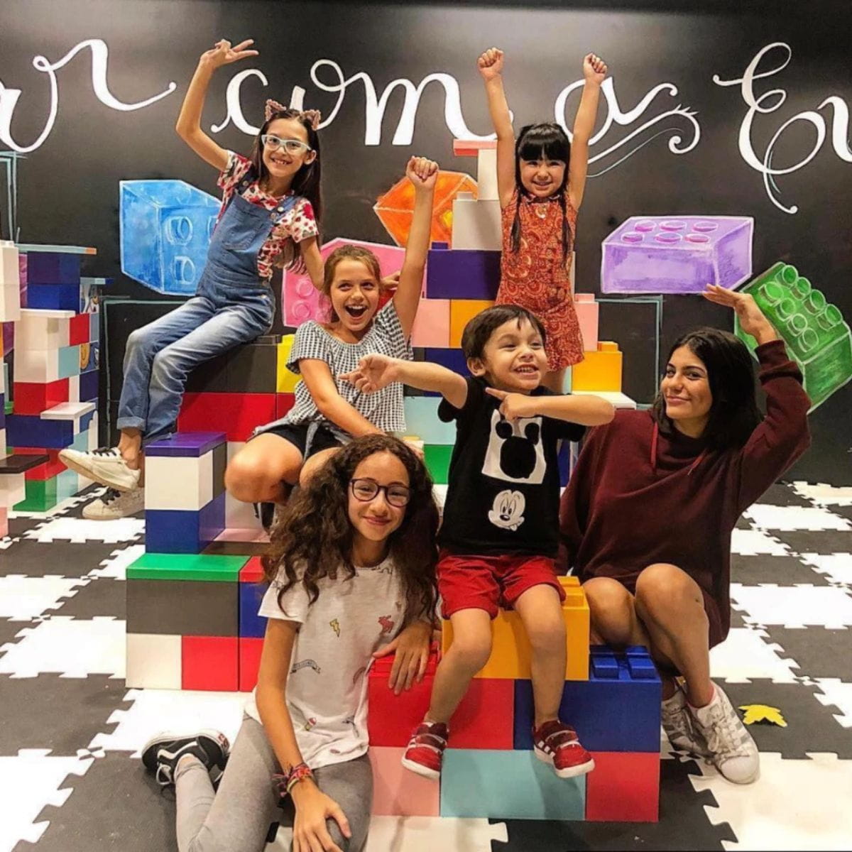 Six kids sitting on their EverBlock Classroom Modular Building Blocks design they made in all the colors