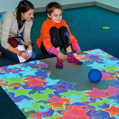 Smiling Kid and Adult playing with design from omiVista Ceiling Mounted Interactive Projector
