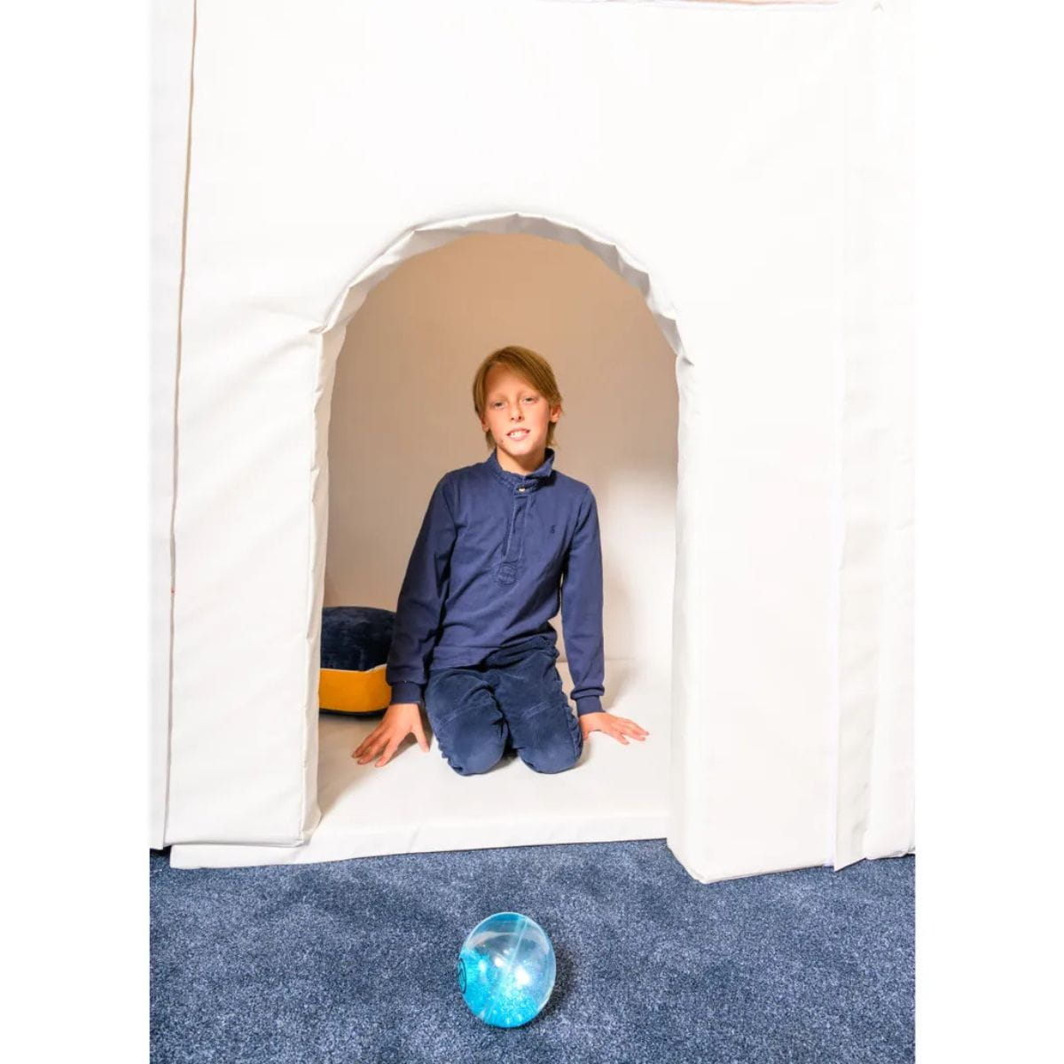 Smiling kid inside the Portable Sensory Play Den