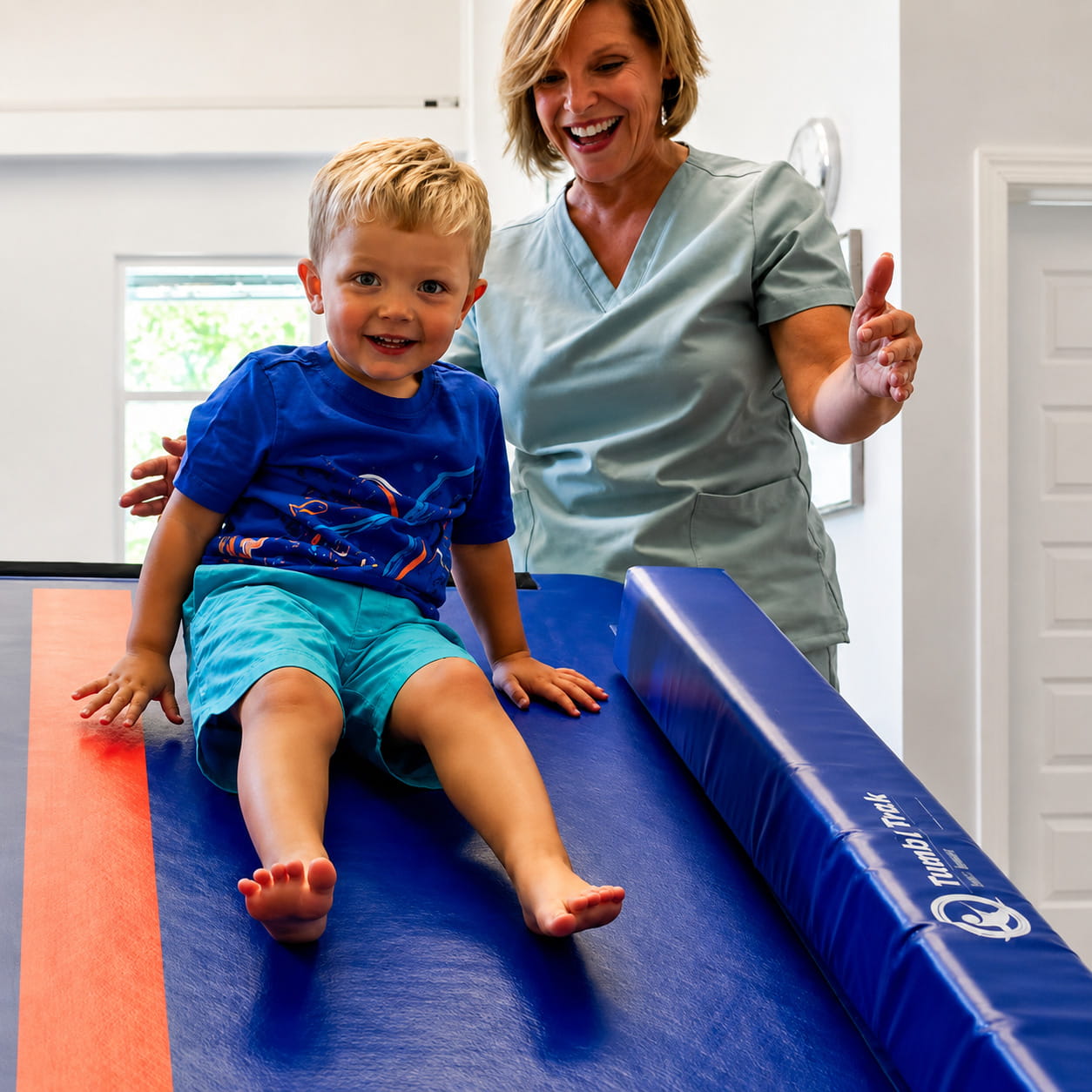 Smiling kid ready to slide down the Tumbl Trak Power Launch
