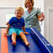 Smiling kid ready to slide down the Tumbl Trak Power Launch