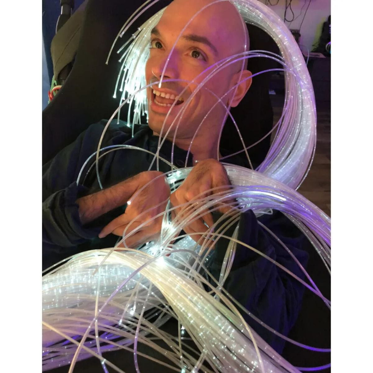 TFH Interactive Fiber Optic Spray tails wrapped around person who is looking at them happily