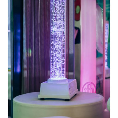 Tabletop Hurricane Tube sitting on platform glowing purple