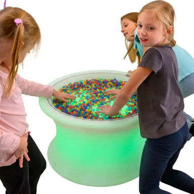Three Kids Playing on the Sensory Mood Light Table with beads in the table