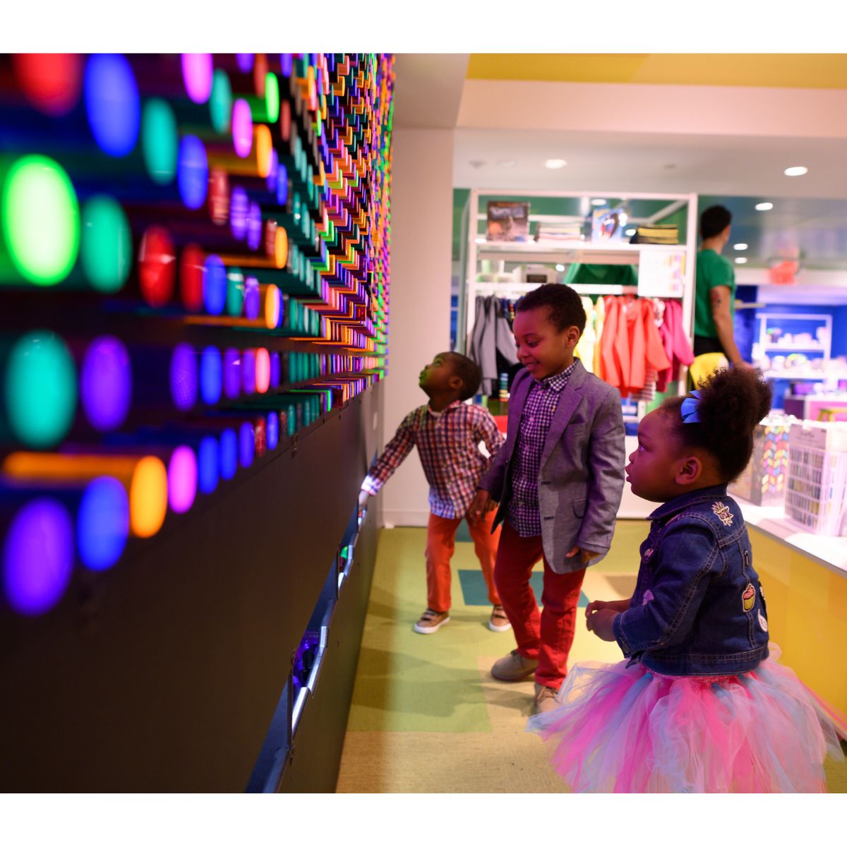 Three kids making designs on the LiteZilla Ineractive Light Wall