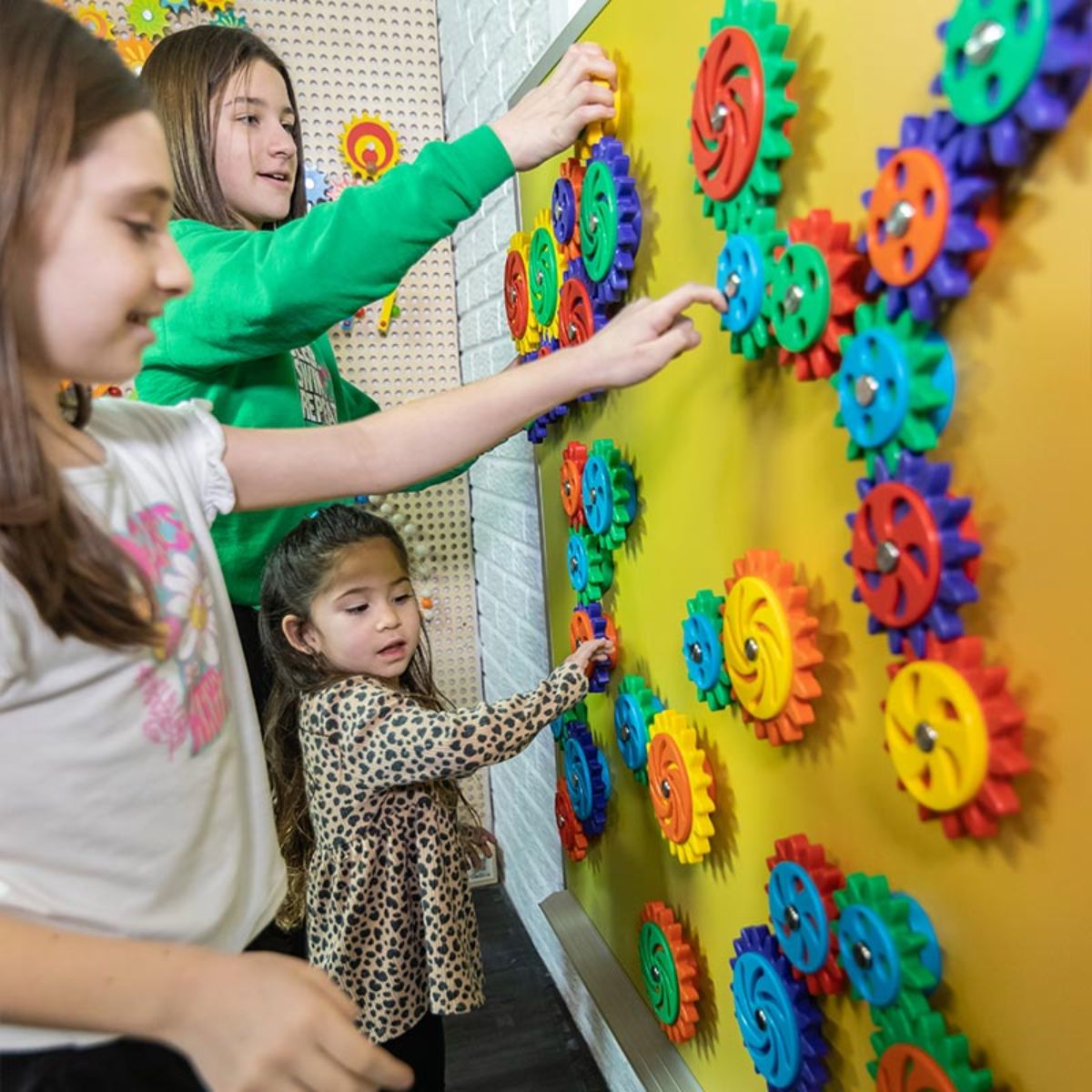 Three kids playing with LiteZilla MagWiz Magnetic Wall Sensory Gears