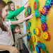 Three kids playing with LiteZilla MagWiz Magnetic Wall Sensory Gears