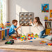 Two kids laughing and playing with the LiteZilla Bubble Wall Mirror Sensory Panels