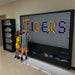 Two kids making a design with Tigers spelled out on the 8x6 LiteZilla Giant Lite Brite Wall