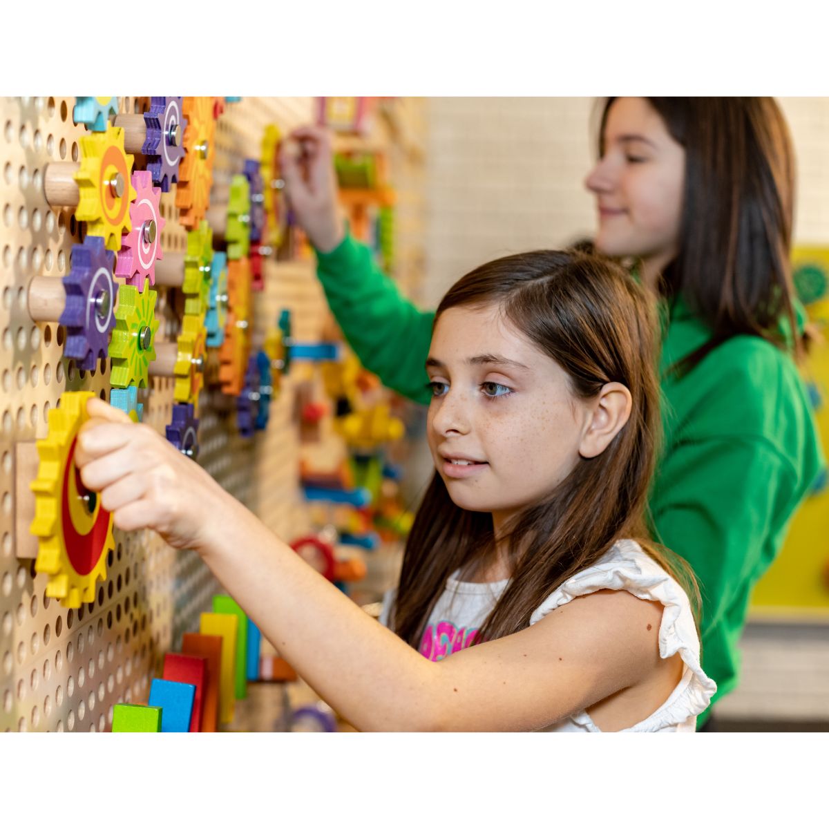 Two kids playing with Gizmo Gears on the LiteZilla Kidworx Interactive Game Board