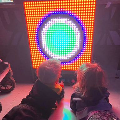 Two kids creating a design on Pixels Pro Interactive Sensory Panel