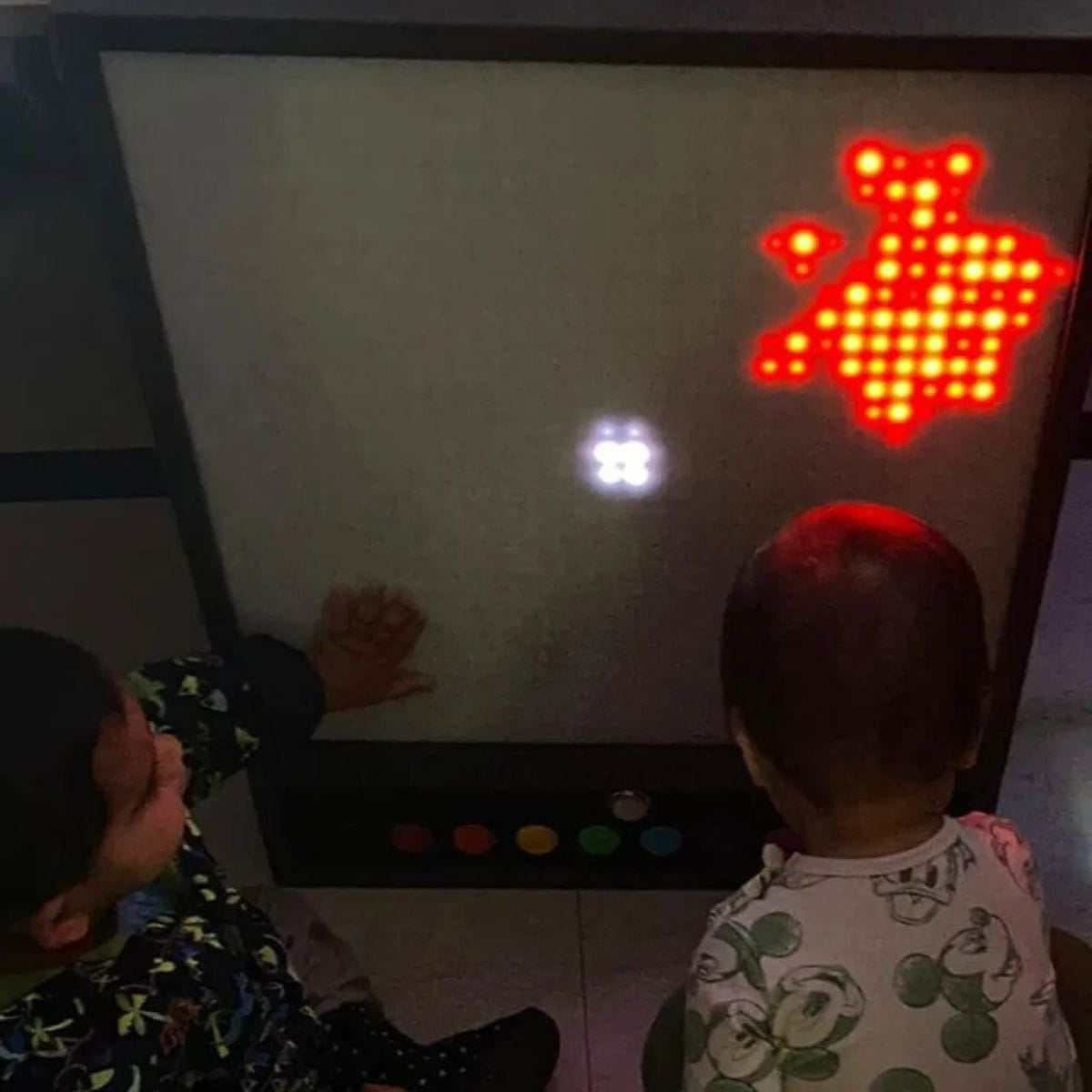 Two kids creating a design on the Pixels Pro Interactive Panel
