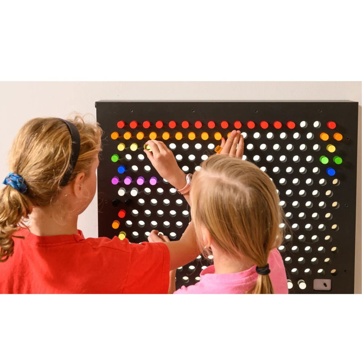 Two kids making a design on the Rod Wall Sensory Light Wall Panel