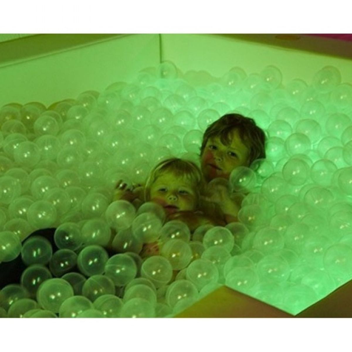 Two kids playing in the Interactive LED Sensory Ball Pool