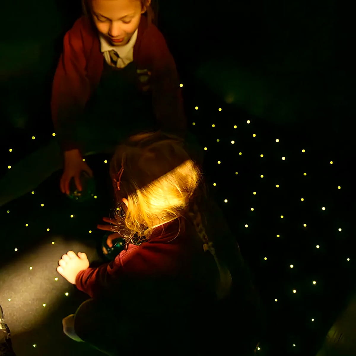 Two kids playing on the TFH LED sensory carpet