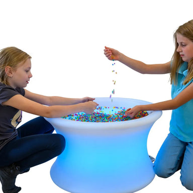 Two kids playing with beads on the Light Up Sensory Table