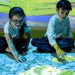 Two kids playing with image on floor from omiVista Mobii Interactive Projector
