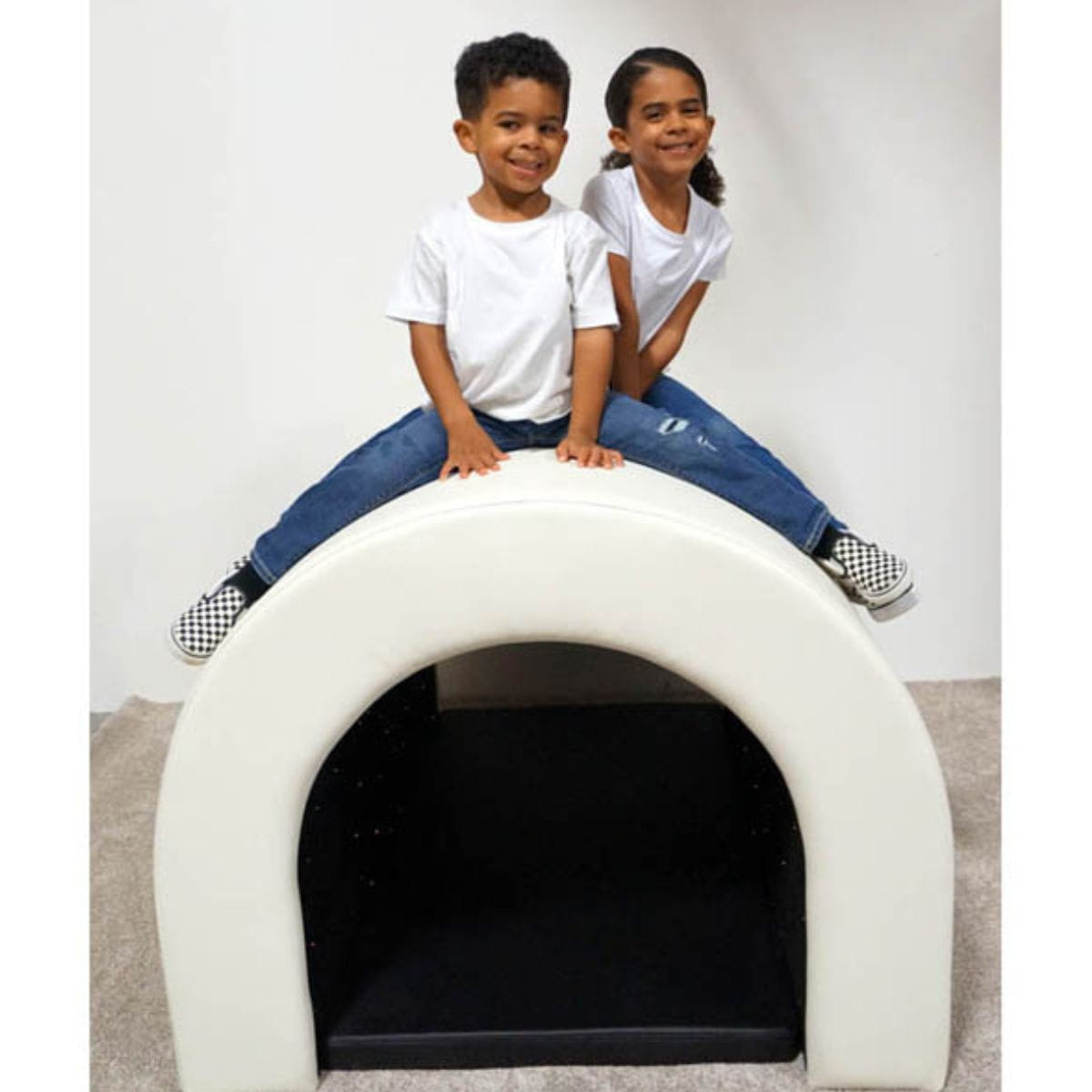 Two kids smiling on top of the Fiber Optic Tranquility Sensory Tunnel