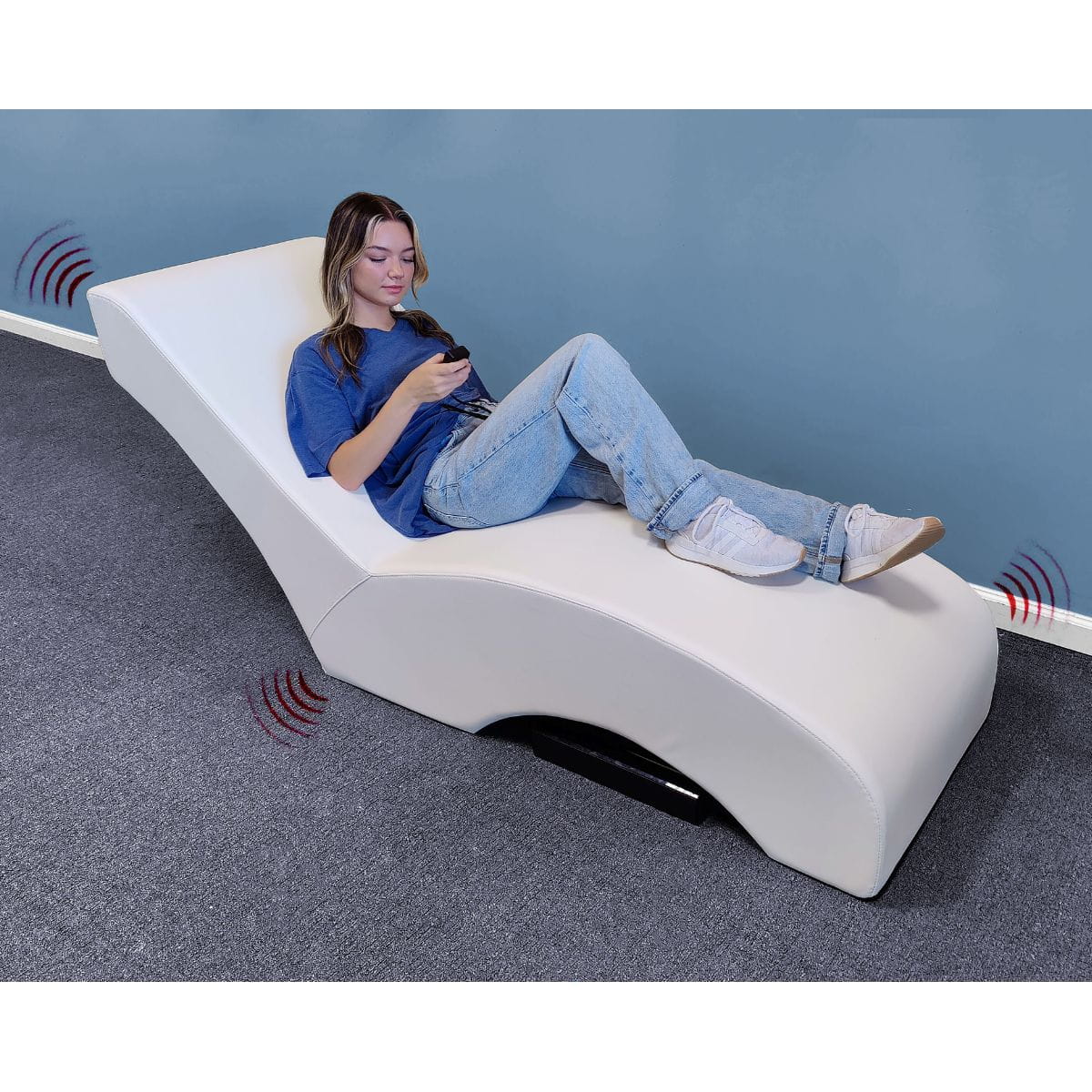Vibro Acoustic Lounge Chair with person on it and controller in hand