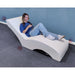 Vibro Acoustic Lounge Chair with person on it and controller in hand
