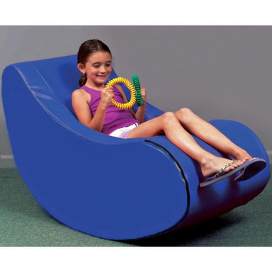 Vibroacoustic Jr Therapy Chair with girl sitting in it playing with two sensory toys