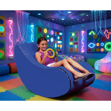 girl sitting in a vibroacoustic chair in a sensory room