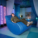man sitting in a vibroacoustic chair in a sensory room